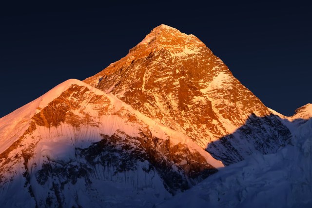 The peak of the highest mountain in the world - Mt. Everest at the sunset.